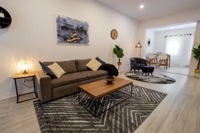 a living room with a couch and a table at BLUE&GOLD - SelfCheckIn - Plateau - St-Laurent in Montréal