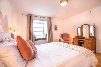 a bedroom with a large white bed and a mirror at GATSBY - SelfCheckIn - Rooftop - Terraces - St-Denis in Montréal