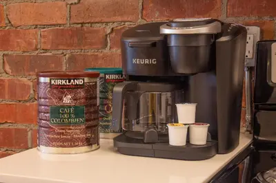 a coffee maker sitting on top of a counter with cups at GATSBY - SelfCheckIn - Rooftop - Terraces - St-Denis in Montréal