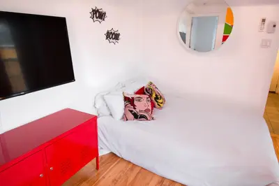 a bedroom with a bed and a red dresser at POP - SelfCheckIn - Rooftop - Terraces - St-Denis in Montréal