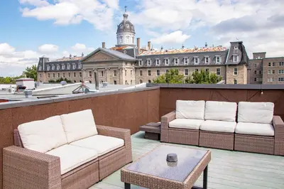 two chairs and a table on a balcony with a building at POP - SelfCheckIn - Rooftop - Terraces - St-Denis in Montréal