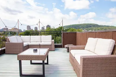 a balcony with couches and a coffee table on a roof at POP - SelfCheckIn - Rooftop - Terraces - St-Denis in Montréal