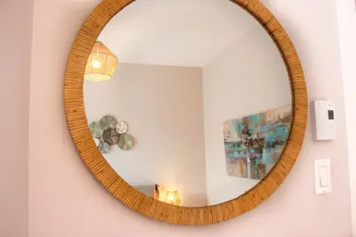 a wooden mirror hanging on a wall in a room at ZEN - SelfCheckIn - Rooftop - Terraces - St-Denis in Montréal