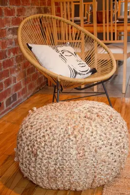 a rattan chair with a pillow and a ottoman at ZEN - SelfCheckIn - Rooftop - Terraces - St-Denis in Montréal