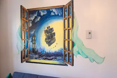 a mural on a wall with a window at FICTION - SelfCheckIn - Rooftop - Terraces - St-Denis in Montréal