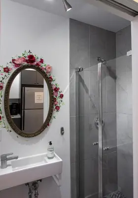 a bathroom with a shower and a sink and a mirror at FICTION - SelfCheckIn - Rooftop - Terraces - St-Denis in Montréal