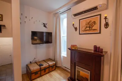 a room with a tv and a table and a window at FICTION - SelfCheckIn - Rooftop - Terraces - St-Denis in Montréal