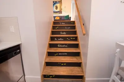 a stairwell in a kitchen with wooden steps at FICTION - SelfCheckIn - Rooftop - Terraces - St-Denis in Montréal