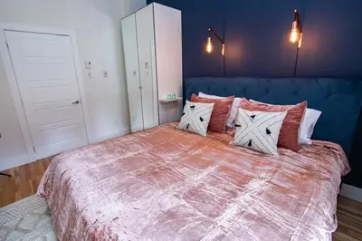 a bedroom with a large bed with red and white pillows at VINTAGE - SelfCheckIn - Rooftop - Terraces - St-Denis in Montréal