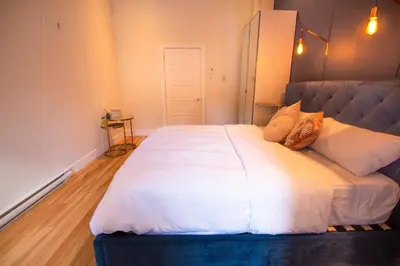 a bedroom with a large bed with white sheets and pillows at VINTAGE - SelfCheckIn - Rooftop - Terraces - St-Denis in Montréal