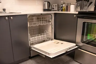 a kitchen with a sink in an open dishwasher at VINTAGE - SelfCheckIn - Rooftop - Terraces - St-Denis in Montréal