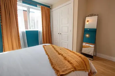 a bedroom with a bed and a mirror at BOHEMIAN - SelfCheckIn - Rooftop - Terraces - St-Denis in Montréal