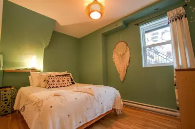 a green bedroom with a bed and a window at BOHEMIAN - SelfCheckIn - Rooftop - Terraces - St-Denis in Montréal