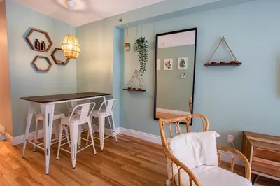 a dining room with a table and chairs and a mirror at BOHEMIAN - SelfCheckIn - Rooftop - Terraces - St-Denis in Montréal