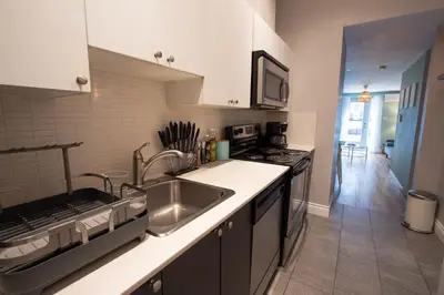 a kitchen with a sink and a stove at BOHEMIAN - SelfCheckIn - Rooftop - Terraces - St-Denis in Montréal