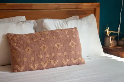 a bed with a brown pillow on top of it at BOHEMIAN - SelfCheckIn - Rooftop - Terraces - St-Denis in Montréal