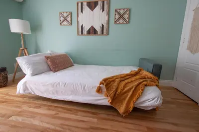 a bedroom with a bed with a blanket on it at BOHEMIAN - SelfCheckIn - Rooftop - Terraces - St-Denis in Montréal