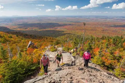 a group of people walking on top of a mountain at *Nouveauté* Foyer au bois, Plage, Montagne et + in Magog-Orford
