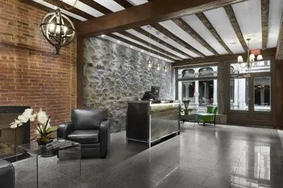 a lobby with chairs and a desk in a building at Hotel Épik Montréal in Montréal