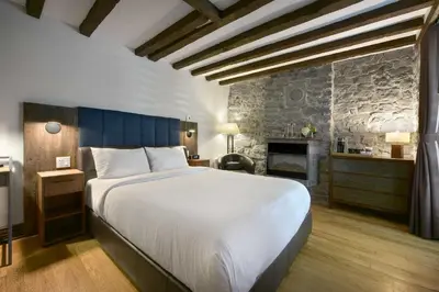 a bedroom with a large bed and a fireplace at Hotel Épik Montréal in Montréal