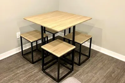a table with two stools and a table and a table and chairs at QUIET Appartment near Montreal CITQ 3O9764 in Longueuil