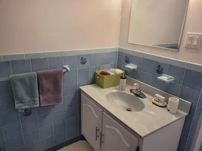 a bathroom with a sink and a mirror and towels at QUIET Appartment near Montreal CITQ 3O9764 in Longueuil