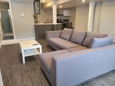 a living room with a couch and a table at QUIET Appartment near Montreal CITQ 3O9764 in Longueuil