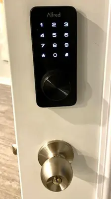 a remote control on a door with a button at QUIET Appartment near Montreal CITQ 3O9764 in Longueuil