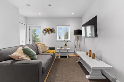 a living room with a couch and a table at Le Karina - Vieux-Terrebonne in Terrebonne