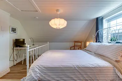 a bedroom with a white bed and a window at Le Havre du Canal in Leclercville