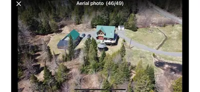 an aerial photo of a house in the woods at Chalet en bois rond in Saint-Herménégilde