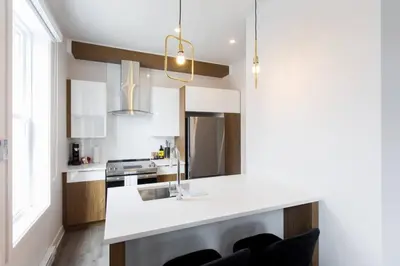 a kitchen with a white counter and a sink at Fresh 1 Bdr in the Heart of Mile End by Denstays in Montréal
