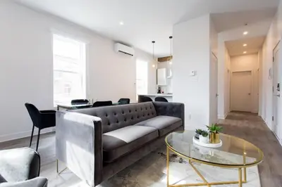 a living room with a couch and a glass table at Fresh 1 Bdr in the Heart of Mile End by Denstays in Montréal