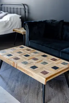 a wooden coffee table with a black couch at Le Black & White - Vieux-Terrebonne in Terrebonne