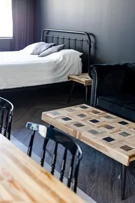 a room with a bed and a table and chairs at Le Black & White - Vieux-Terrebonne in Terrebonne