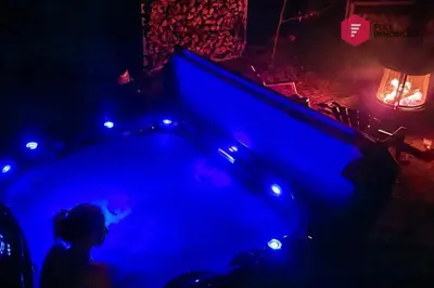 a pool table in a dark room with blue lights at Aux Berges du Pont Suspendu / Grand Lac Brompton in Saint Denis de Brompton