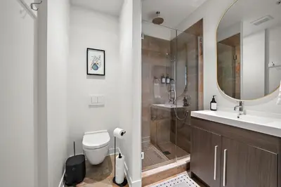 a bathroom with a toilet and a sink and a shower at The Nomad Saint Jacques in Montréal