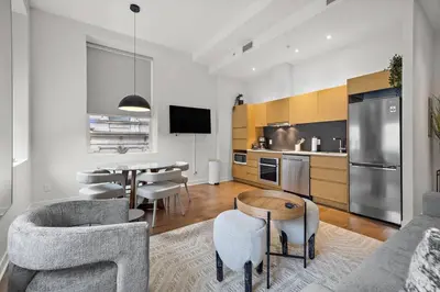 a kitchen and living room with a table and chairs at The Nomad Saint Jacques in Montréal