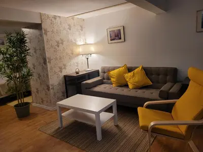 a living room with a couch and a table at L ' Arlequin Suite et logement in Vaudreuil-Dorion