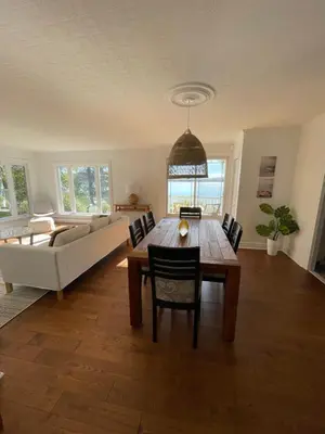 a living room with a table and a couch at Chalet KLS Lac D'Argent in Eastman