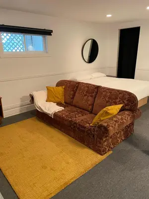 a living room with a couch and a bed at Chalet KLS Lac D'Argent in Eastman