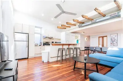 a living room with a blue couch and a table at Luminous and Stylish Renovated Apt in LePlateau in Montréal