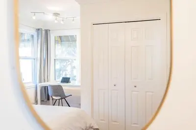a mirror reflecting a bedroom with a white closet at Luminous and Stylish Renovated Apt in LePlateau in Montréal