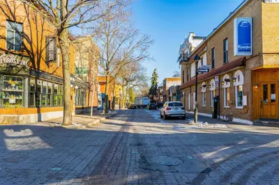 a city street with a car parked on the street at Luminous and Stylish Renovated Apt in LePlateau in Montréal