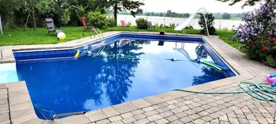 a swimming pool with a water slide in a yard at Lady Eden Waterfront Mansion - No party in Montréal