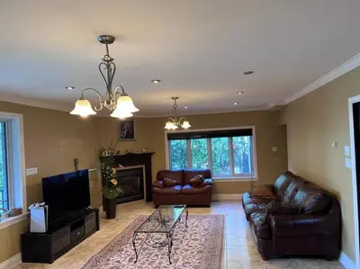 a living room with leather furniture and a fireplace at Lady Eden Waterfront Mansion - No party in Montréal