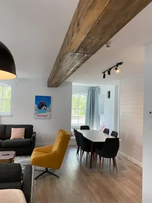 a living room with a table and chairs at Bromont Lodge in Bromont