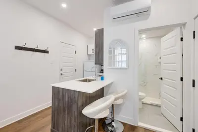 a white bathroom with a sink and a toilet at Le Mile End by M11 - Upscale Studio with Queen Bed in Montréal