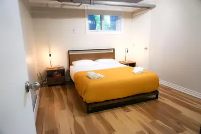 a bedroom with a bed with two towels on it at Cozy apartment in Ahuntsic with Free Parking and near metro station in Montréal