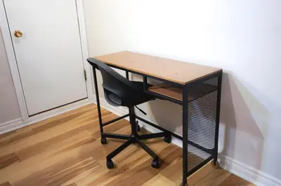 a desk with a chair next to a wall at Cozy apartment in Ahuntsic with Free Parking and near metro station in Montréal